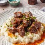 Steak bites with garlic butter on mashed potatoes