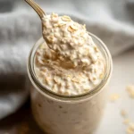 Creamy overnight oats on spoon in jar