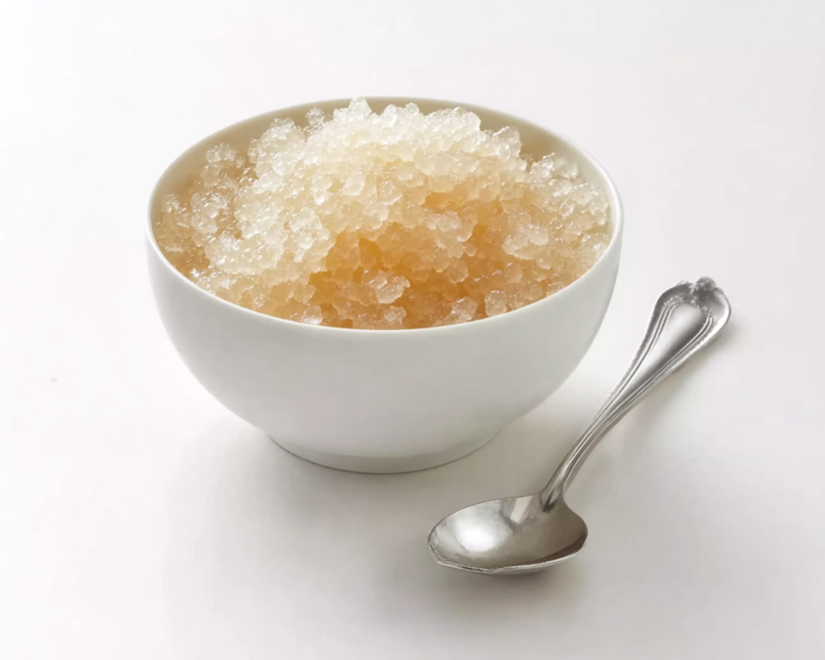 Bloomed gelatin crystals in white bowl