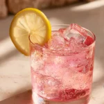 pink iced drink with lemon slice