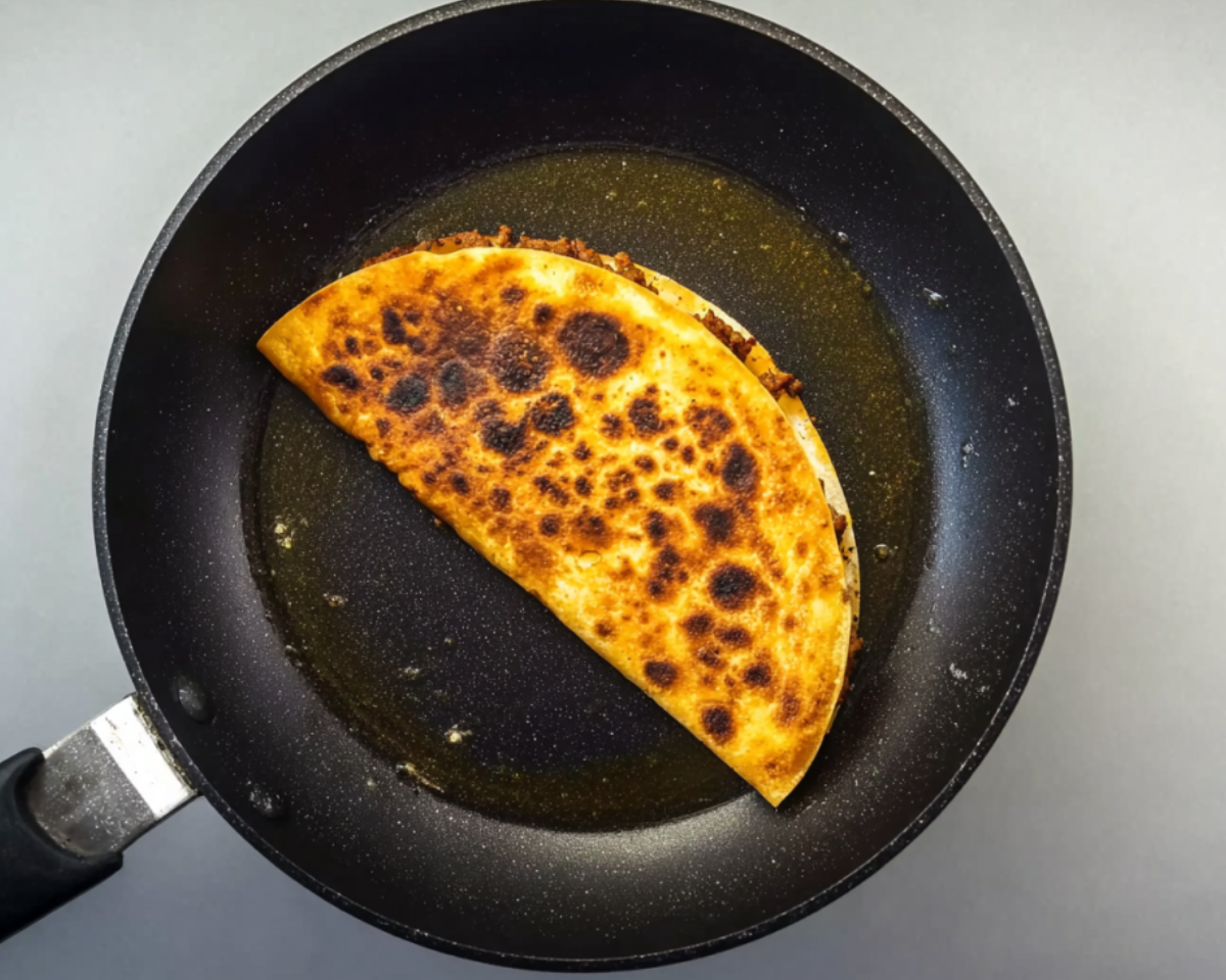 taco dorado frying in pan