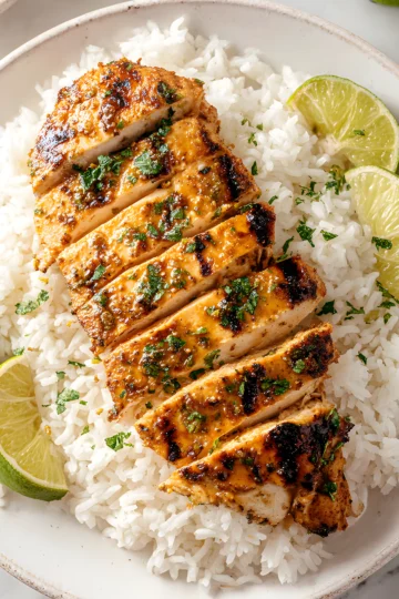grilled chicken slices on rice with lime